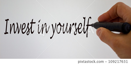 Hand writing 'invest in yourself', isolated on white background. Hand writing 'invest in yourself', isolated on white background. 109217631
