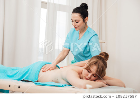 health osteopathy massage therapist gives massage to the client in the office 109217687