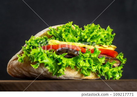 Sandwich in a pita with vegetables, salad. Vegan. Keto. Homemade sandwiches. Healthy fast food. On a wooden board Sandwich in a pita with vegetables, salad. Vegan. Keto. Homemade sandwiches. Healthy fast food. On a wooden board 109217771