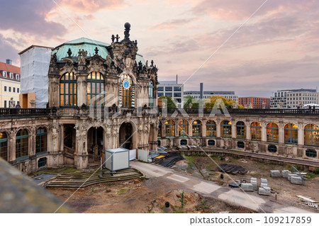 Dresden Zwinger palace king inner courtyard under reconstruction and renovation with dramatic sunset sky background. German architecture landmark building garden repair landscaping Dresden Zwinger palace king inner courtyard under reconstruction and renovation with dramatic sunset sky background. German architecture landmark building garden repair landscaping 109217859