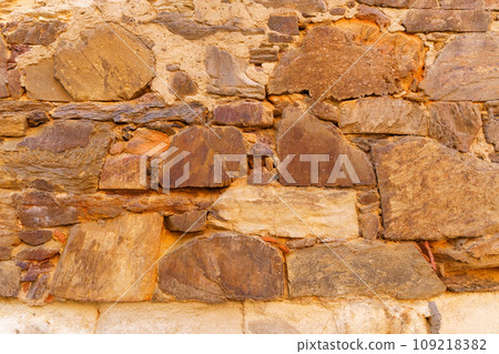 Background of an old wall made of red stone. 109218382