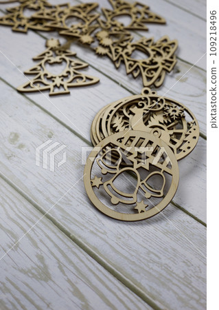 Flat wooden toy with New Year's bells for decorating the Christmas tree Flat wooden toy with New Year's bells for decorating the Christmas tree 109218496