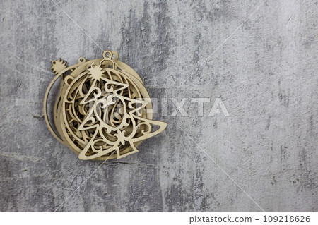 Toy in the shape of a Christmas tree lies on a set of round wooden toys for the New Year Toy in the shape of a Christmas tree lies on a set of round wooden toys for the New Year 109218626