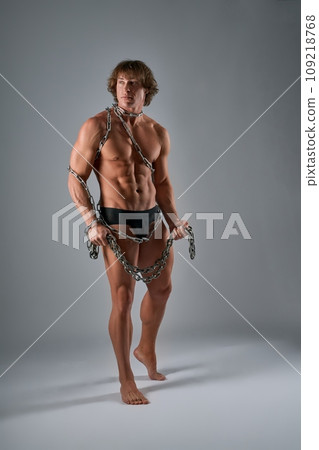 Shirtless modern gladiator with chains all over his body Shirtless modern gladiator with chains all over his body 109218768