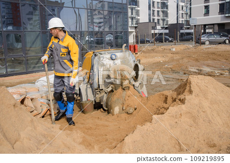 A builder in work clothes is doing his job 109219895