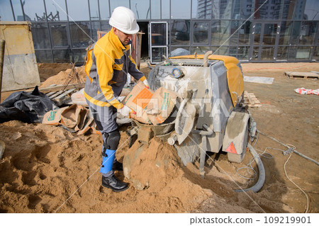 A builder in work clothes is doing his job 109219901