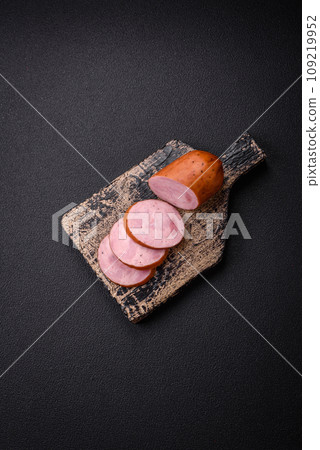 Delicious smoked sausage with salt and spices cut into slices Delicious smoked sausage with salt and spices cut into slices 109219952