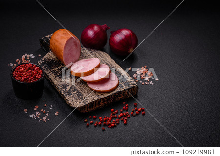 Delicious smoked sausage with salt and spices cut into slices 109219981