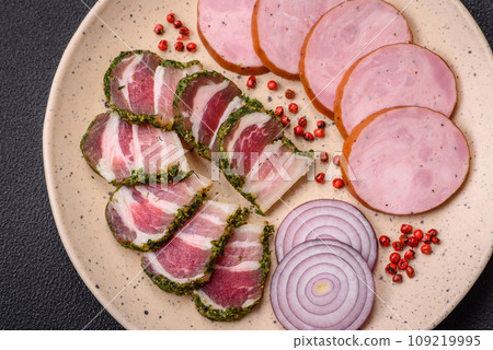 Delicious smoked sausage with salt and spices cut into slices Delicious smoked sausage with salt and spices cut into slices 109219995