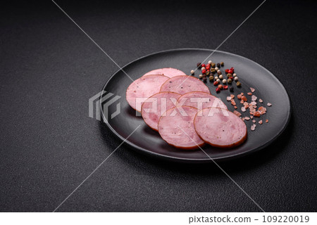 Delicious smoked sausage with salt and spices cut into slices 109220019