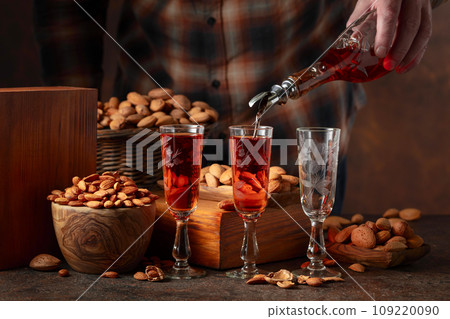 Italian liqueur Amaretto with almonds nuts. Italian liqueur Amaretto with almonds nuts. 109220090