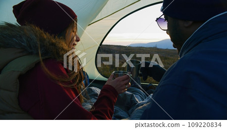 Caucasian woman holding cup and talking with African American man Caucasian woman holding cup and talking with African American man 109220834