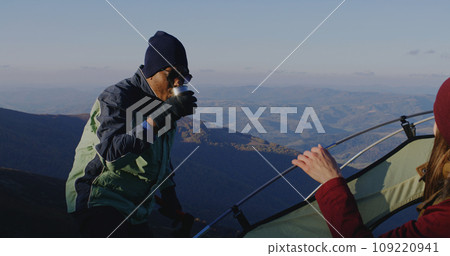 Multiethnic backpacker friends rest during a hike Multiethnic backpacker friends rest during a hike 109220941