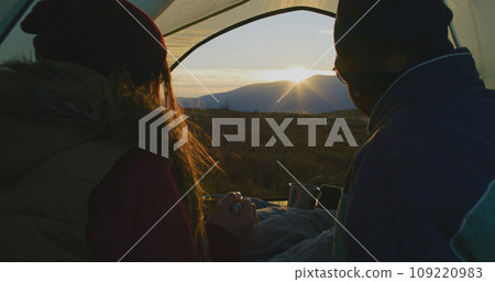 Close up of African American man sitting in tent with Caucasian wife Close up of African American man sitting in tent with Caucasian wife 109220983