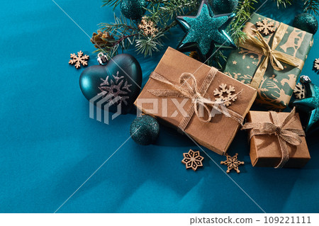 Christmas background. Gift boxes tied ribbons and christmas decorations on turquoise background. Christmas background. Gift boxes tied ribbons and christmas decorations on turquoise background. 109221111