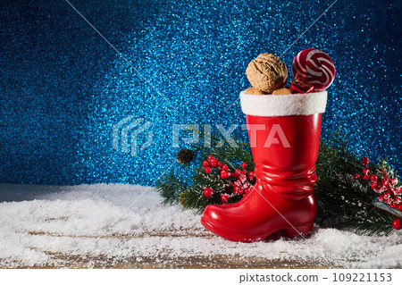 St. Nicholas Day. Red boot with sweets, spicy ginger cookies and gifts for December 6th St. Nicholas Day. Red boot with sweets, spicy ginger cookies and gifts for December 6th 109221153