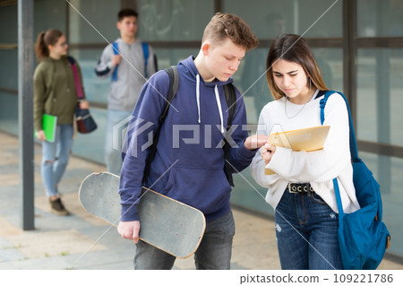 Teenage girl and boy talking outside 109221786