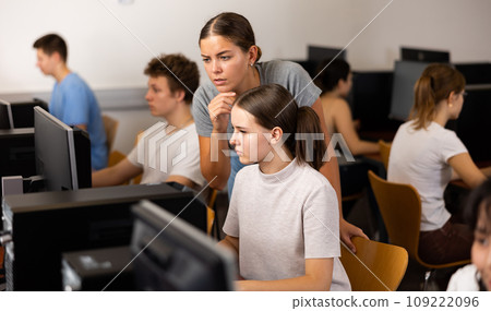 Teacher and teenage girl studying computer science Teacher and teenage girl studying computer science 109222096
