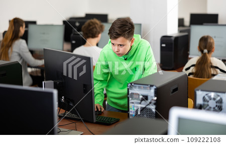 Portrait of students at computers in computer class Portrait of students at computers in computer class 109222108
