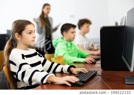 Schoolgirl using PC during computer science lesson 109222132
