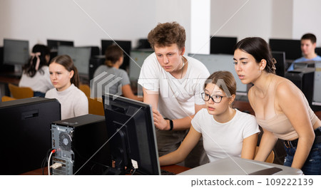 Clever teenagers helping to the female classmate while she is learning computer science in the class Clever teenagers helping to the female classmate while she is learning computer science in the class 109222139
