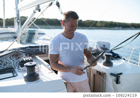 Charismatic man in white clothes on a yacht 109224119