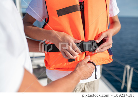 Close up of a person wearing a life-jacket Close up of a person wearing a life-jacket 109224195