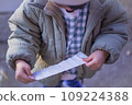 A child opening a fortune teller 109224388