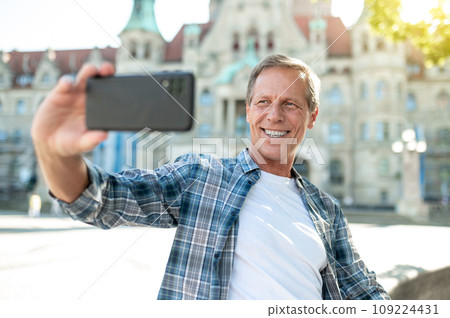 Man making selfie with city on background. Man making selfie with city on background. 109224431