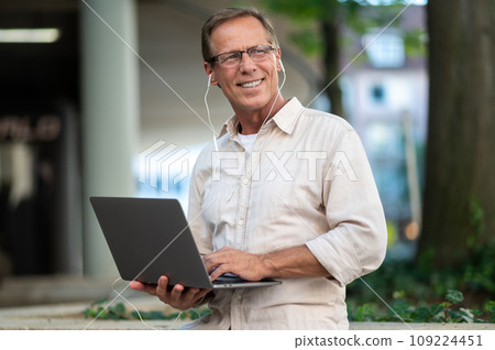 Man working online with laptop computer outdoor. Man working online with laptop computer outdoor. 109224451