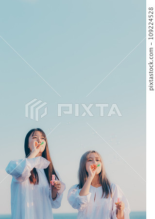 兩個年輕女子在海邊玩肥皂泡 109224528