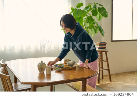 A woman serving food on the table on a holiday morning 109224904