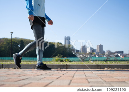 Healthy woman running and walking outside Healthy woman running and walking outside 109225190