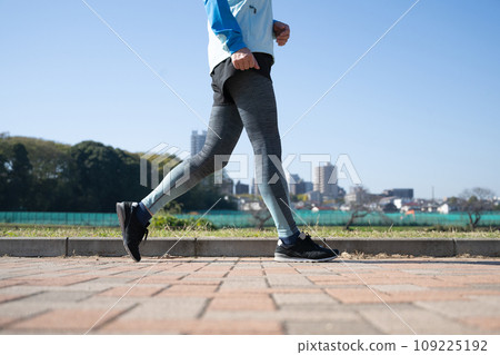 Healthy woman running and walking outside 109225192