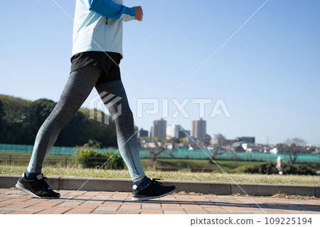 Healthy woman running and walking outside 109225194