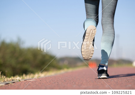 Feet of a healthy woman running outside Feet of a healthy woman running outside 109225821