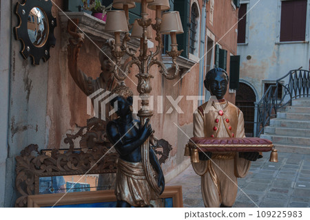 A statue of a black child serving in a luxury style in Venice, Italy. 109225983