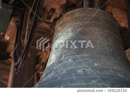 Large bell inside a Venetian building, possibly a church or restaurant. No inscriptions or decorations visible. Unknown location and angle. No landmarks or famous places visible. Large bell inside a Venetian building, possibly a church or restaurant. No inscriptions or decorations visible. Unknown location and angle. No landmarks or famous places visible. 109226150