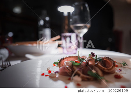 Close-up shot of a delicious meal with a glass of wine on a table. Perfect for dining, restaurant, and food and drink concepts. Close-up shot of a delicious meal with a glass of wine on a table. Perfect for dining, restaurant, and food and drink concepts. 109226199
