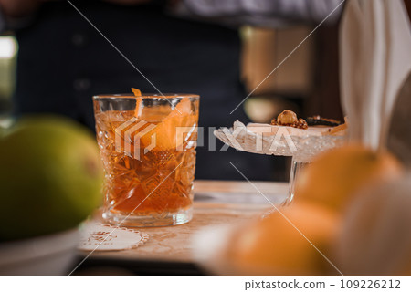 Enjoy a classic cocktail in a luxury setting in Venice, Italy. This close-up photo captures the elegance of the drink, perfect for a sophisticated night out. Enjoy a classic cocktail in a luxury setting in Venice, Italy. This close-up photo captures the elegance of the drink, perfect for a sophisticated night out. 109226212