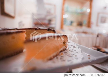 Delicious slice of cake on a white plate in a Venetian restaurant. Simple presentation with no specific decoration. Part of a collection showcasing summer in Venice, Italy. Delicious slice of cake on a white plate in a Venetian restaurant. Simple presentation with no specific decoration. Part of a collection showcasing summer in Venice, Italy. 109226465