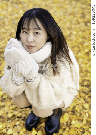 Young woman enjoying autumn leaves hunting Young woman enjoying autumn leaves hunting 109226843