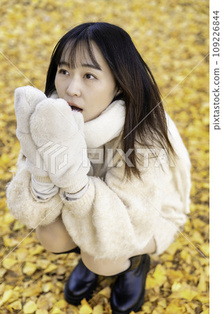 Young woman enjoying autumn leaves hunting Young woman enjoying autumn leaves hunting 109226844