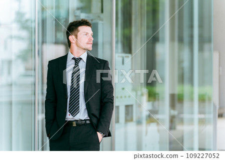 Western businessman standing in front of a building, overseas business trip, overseas assignment, trading company, trade Western businessman standing in front of a building, overseas business trip, overseas assignment, trading company, trade 109227052