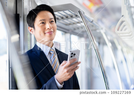 Businessman on a commuter train Photography cooperation: Keio Electric Railway Co., Ltd. Businessman on a commuter train Photography cooperation: Keio Electric Railway Co., Ltd. 109227169