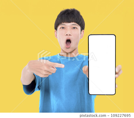 Happy Asian teenaher student holding smartphone mockup of blank screen 109227695