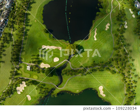 Aerial view of beautiful green golf field fairway and putting green,Top view image for sport background and travel nature background, Amazing green nature view Aerial view of beautiful green golf field fairway and putting green,Top view image for sport background and travel nature background, Amazing green nature view 109228034