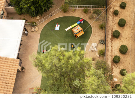 Aerial Top View Of Backyard with Play Yard or Playground Trees and Lawn. Residential Area. Relaxing Outdoor Area. Horizontal Plane Aerial Top View Of Backyard with Play Yard or Playground Trees and Lawn. Residential Area. Relaxing Outdoor Area. Horizontal Plane 109230281