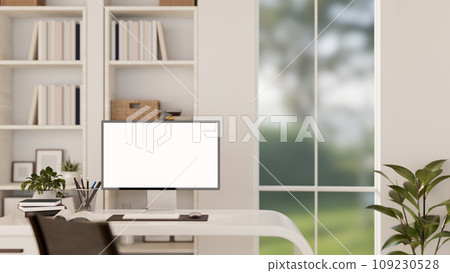 A modern white office workspace with a white-screen computer monitor mockup on a desk. 109230528