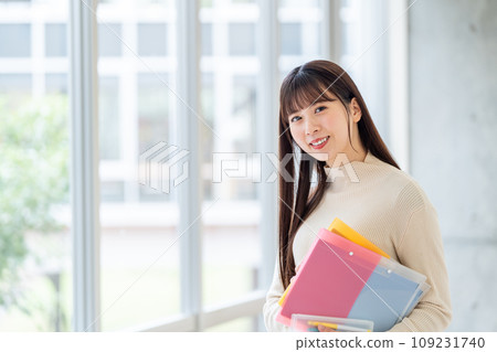 Female university student standing in the hallway Photography cooperation: Ariake College of Education and Arts Female university student standing in the hallway Photography cooperation: Ariake College of Education and Arts 109231740